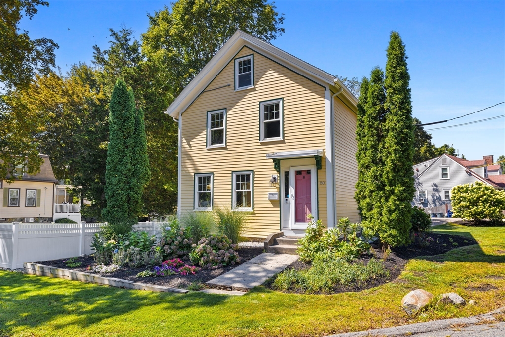 80 Washington Street Stoneham, MA 02180 - Photo 2 of 21 a front view of a house with a yard garage and outdoor seating