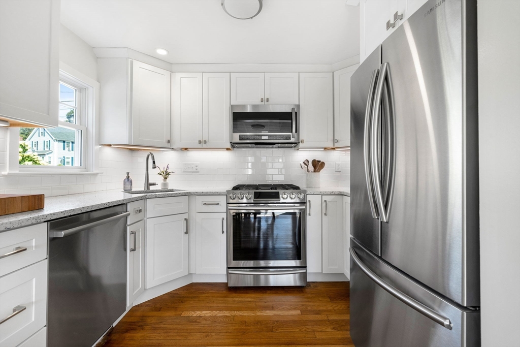 80 Washington Street Stoneham, MA 02180 - Photo 4 of 21 a kitchen with stainless steel appliances granite countertop a stove a refrigerator and a sink