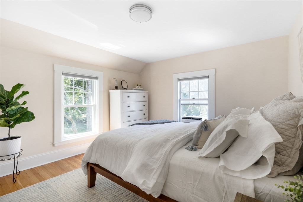80 Washington Street Stoneham, MA 02180 - Photo 10 of 21 a bedroom with a bed and a potted plant