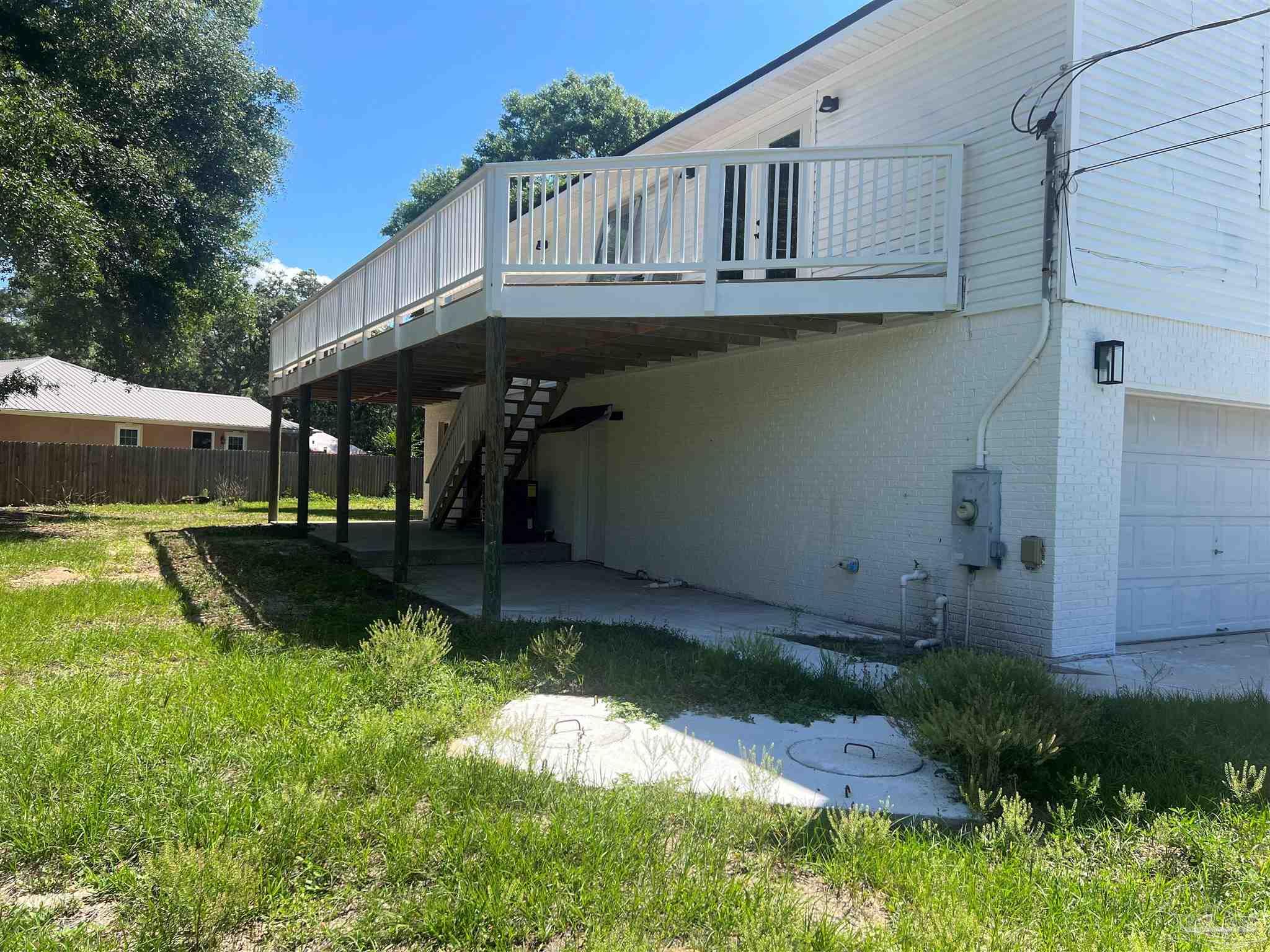 3111 Holley Point Road Navarre, FL 32566 - Photo 12 of 23 a backyard of a house with yard and retail shops