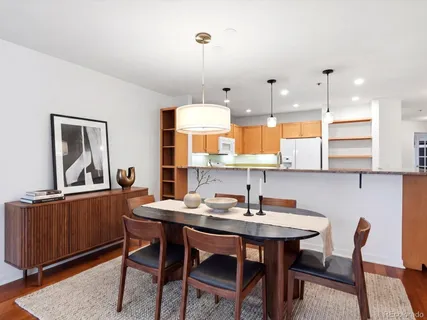 a kitchen with stainless steel appliances granite countertop a sink a stove and a refrigerator