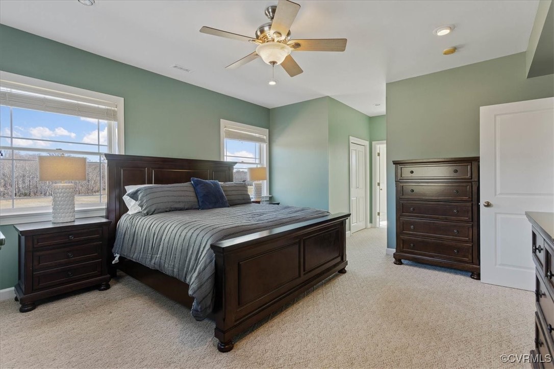 3008 New Design Road Dendron, VA 23839 - Photo 19 of 46 a spacious bedroom with a bed and a chandelier