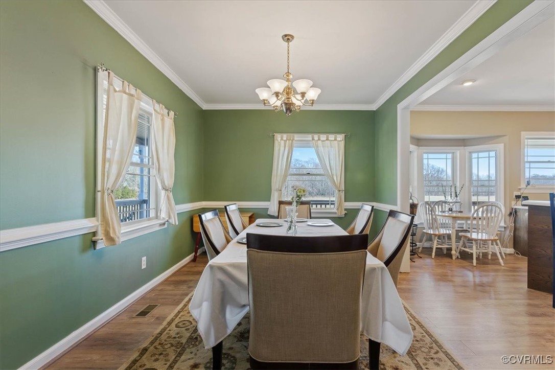 3008 New Design Road Dendron, VA 23839 - Photo 6 of 46 a view of a dining room with furniture window and wooden floor