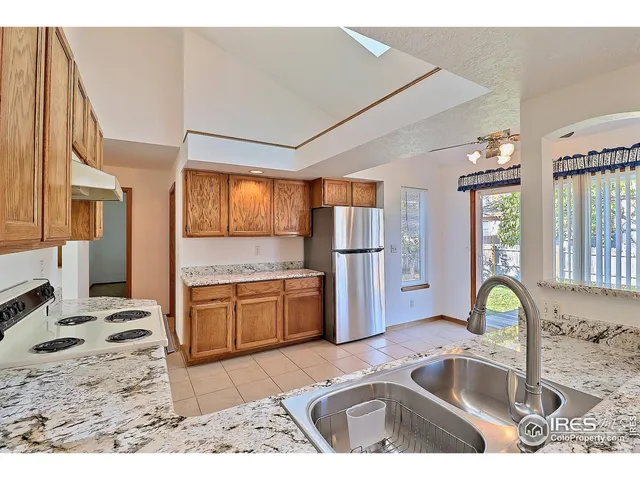 a kitchen with a sink stove and refrigerator