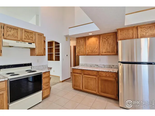 a kitchen with stainless steel appliances granite countertop a stove a refrigerator and a microwave