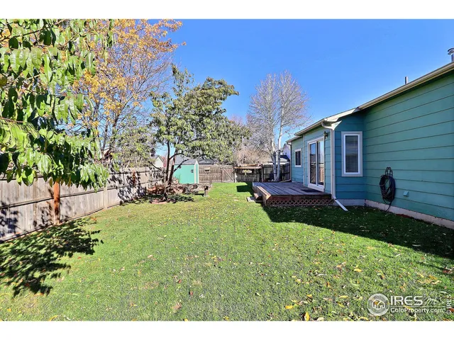 a view of a house with a yard and potted plants