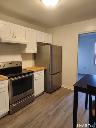 a kitchen with a stove a microwave and a refrigerator