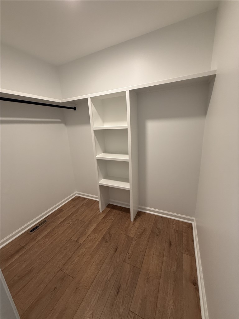 317 Dixie Drive Seneca, SC 29672 - Photo 4 of 7 This organized walk-in closet offers practical storage solutions with built-in shelving and hanging space.