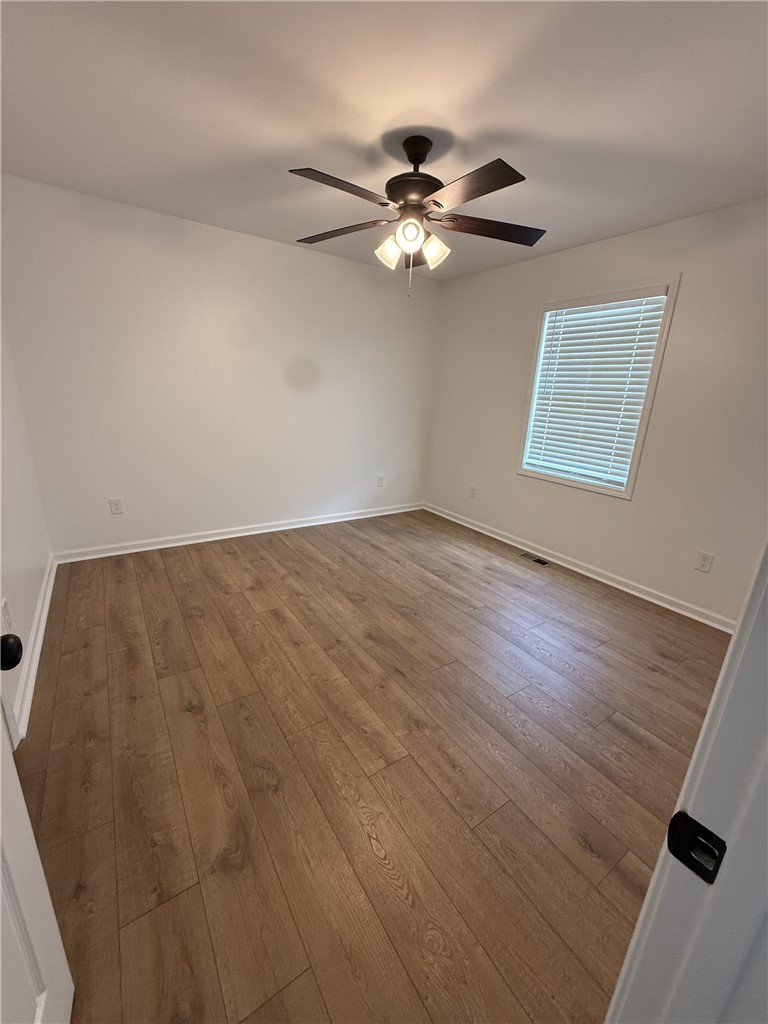 317 Dixie Drive Seneca, SC 29672 - Photo 7 of 7 This spacious room features rich wood flooring, crisp walls, and ample natural light.