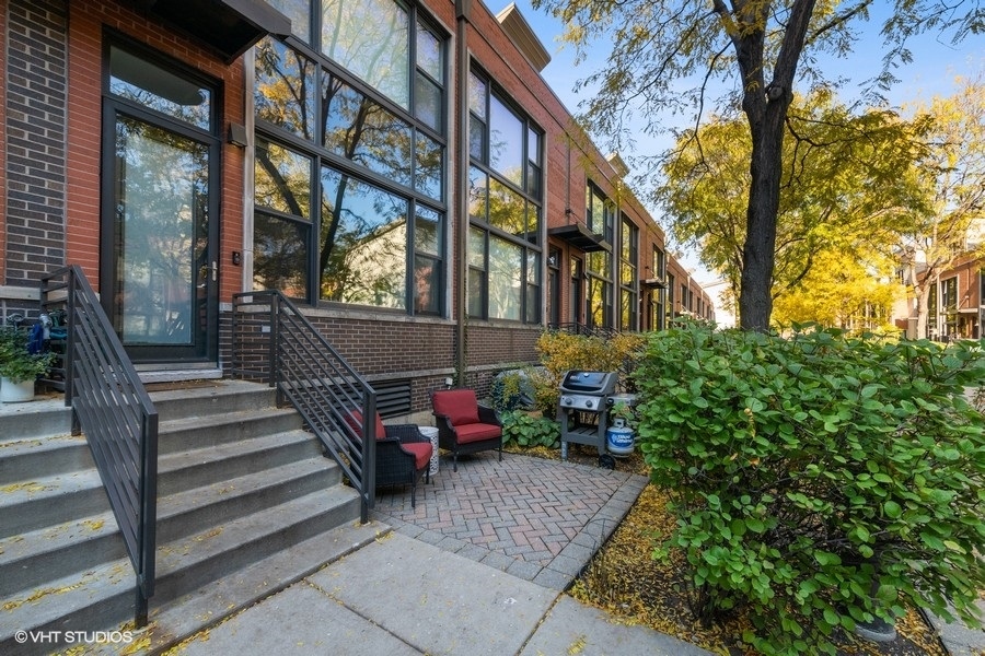 a view of a building with sitting area and garden