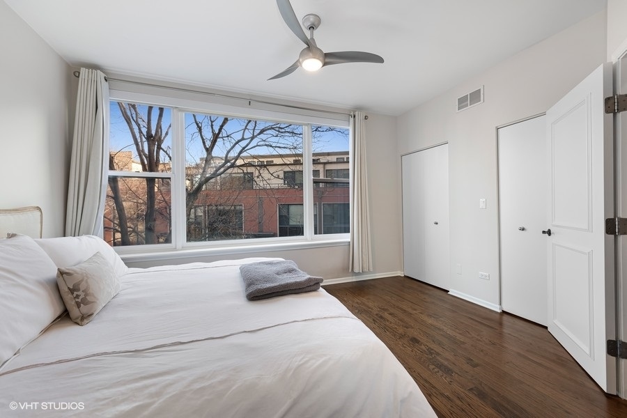908 North Howe Street Chicago, IL 60610 - Photo 14 of 25 a bedroom with a bed and a large window