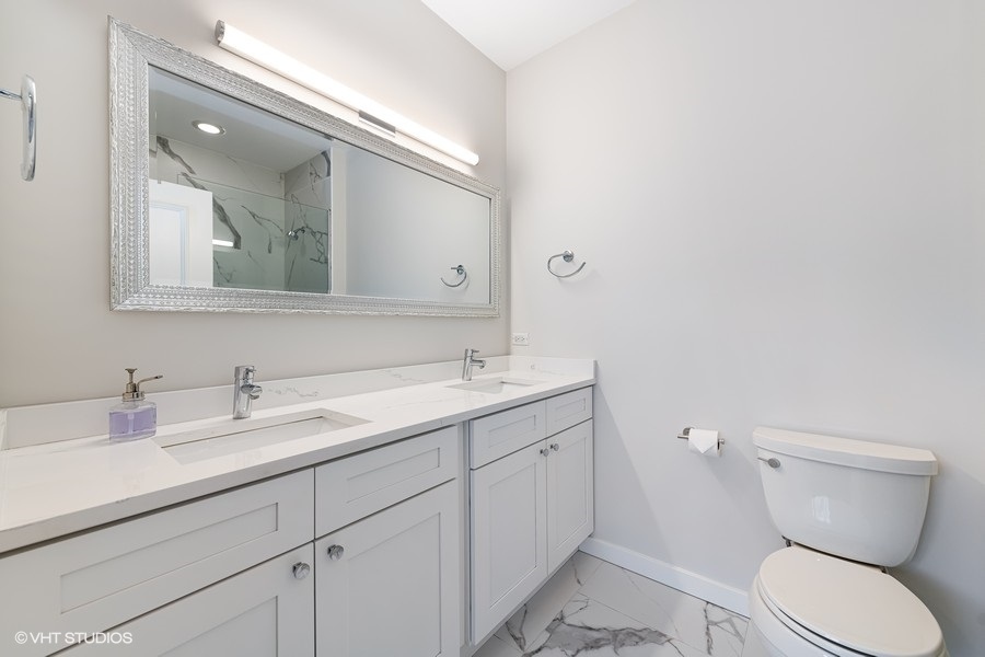 908 North Howe Street Chicago, IL 60610 - Photo 15 of 25 a bathroom with a toilet sink and mirror