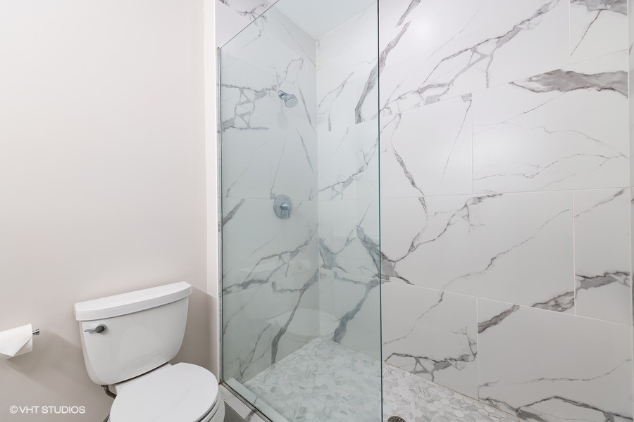 908 North Howe Street Chicago, IL 60610 - Photo 16 of 25 a white toilet sitting next to a shower