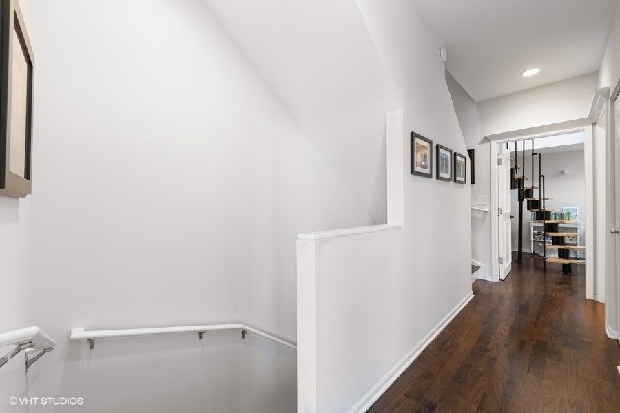 908 North Howe Street Chicago, IL 60610 - Photo 20 of 25 a view of a hallway with wooden floor and a bathroom