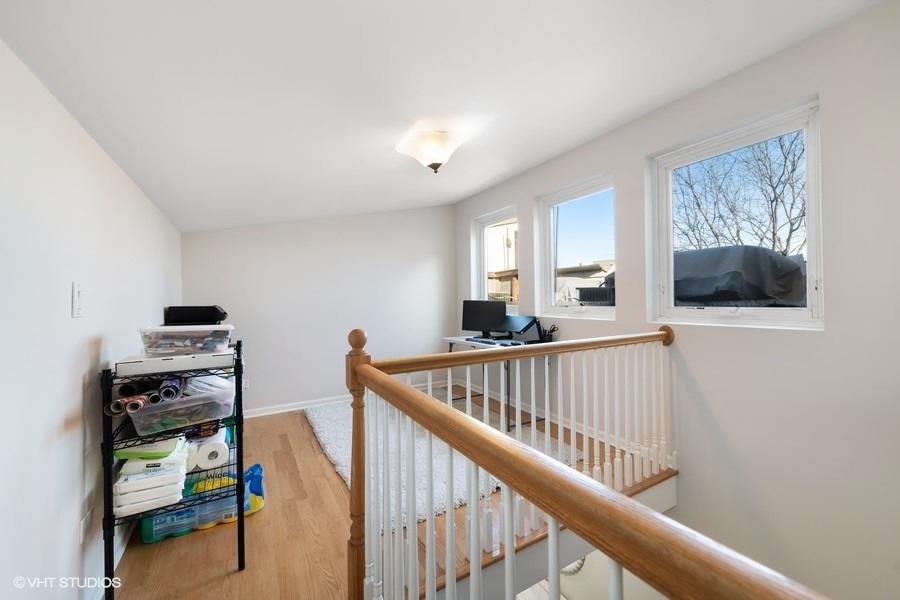 908 North Howe Street Chicago, IL 60610 - Photo 21 of 25 a view of a hallway with workspace and wooden floor