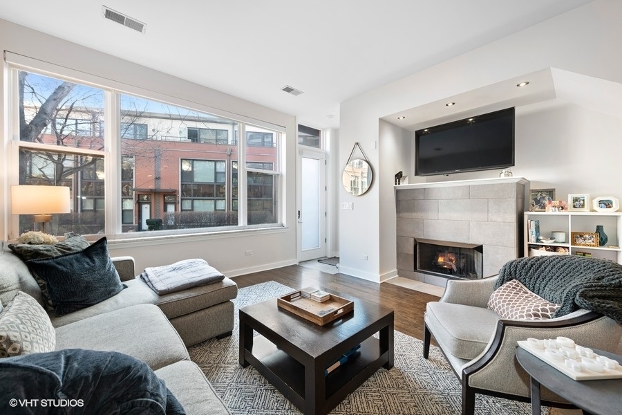 908 North Howe Street Chicago, IL 60610 - Photo 4 of 25 a living room with furniture a flat screen tv and a fireplace