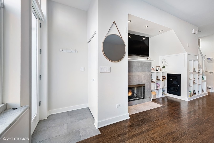 908 North Howe Street Chicago, IL 60610 - Photo 5 of 25 a view of a livingroom with a fireplace a flat screen tv and entryway