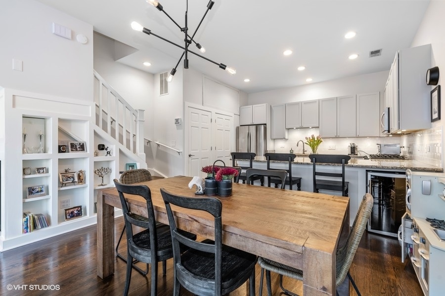 908 North Howe Street Chicago, IL 60610 - Photo 7 of 25 a kitchen with stainless steel appliances kitchen island granite countertop a dining table chairs and granite counter tops