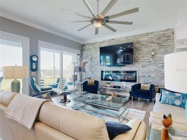 a kitchen with kitchen island a stove a refrigerator and a dining table with wooden floor