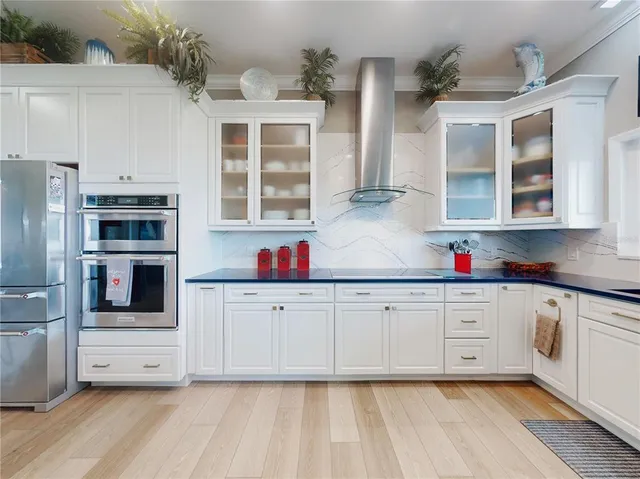 a dining room with furniture potted plants and wooden floor