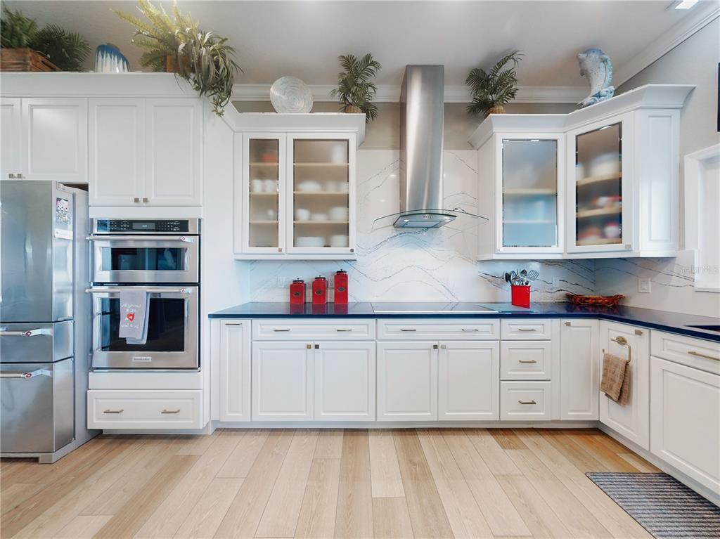2019 South Riverside Drive Edgewater, FL 32141 - Photo 15 of 94 a kitchen with granite countertop white cabinets and stainless steel appliances