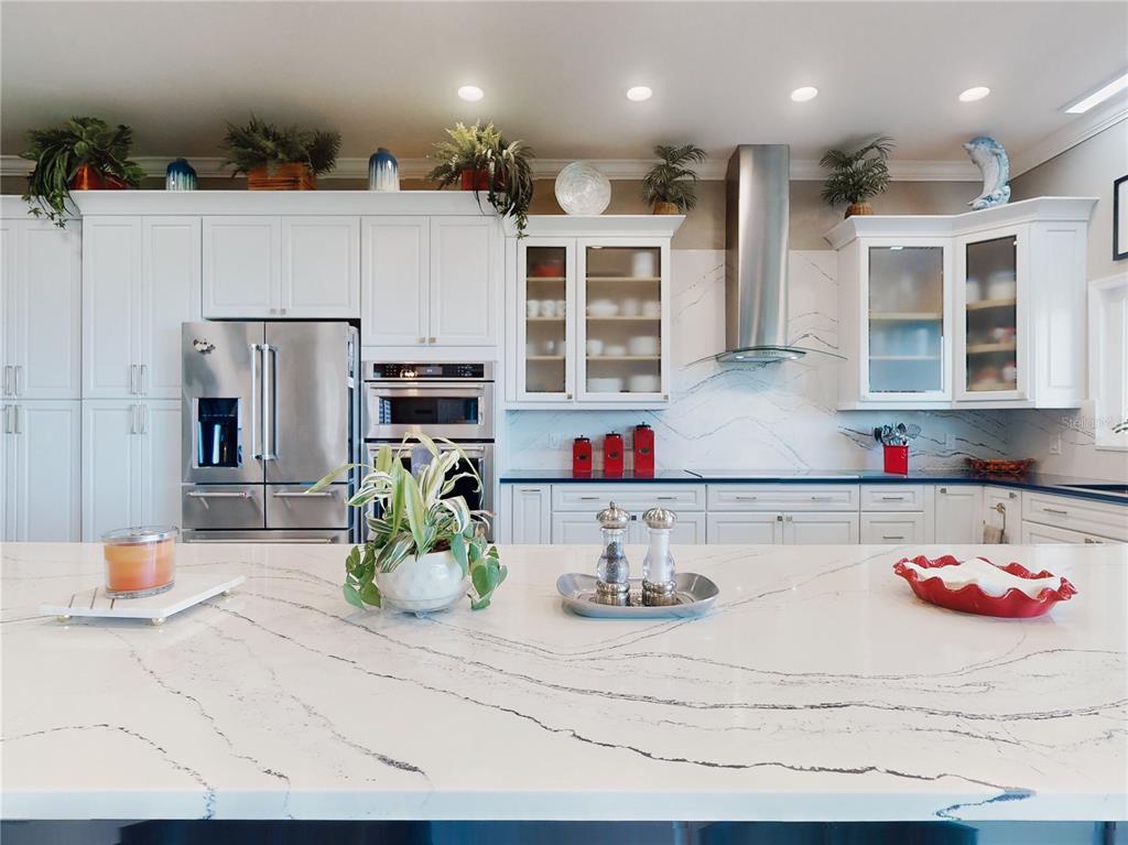 2019 South Riverside Drive Edgewater, FL 32141 - Photo 20 of 94 a kitchen with stainless steel appliances kitchen island granite countertop a white refrigerator a oven and a sink