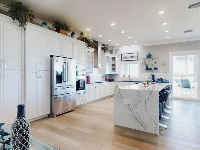 a bathroom with a double vanity sink toilet and shower