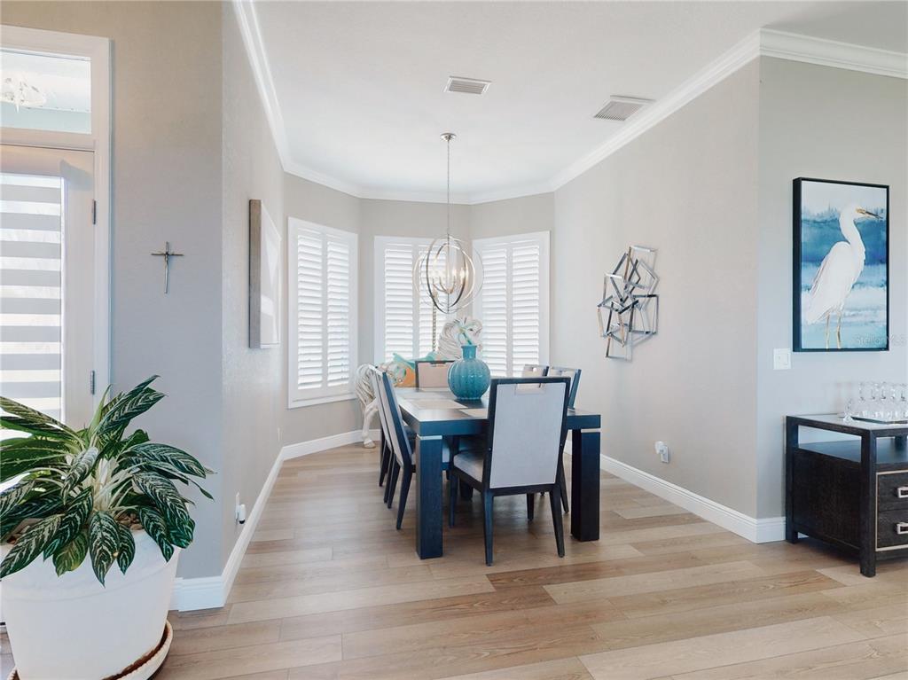 2019 South Riverside Drive Edgewater, FL 32141 - Photo 22 of 94 a dining room with furniture potted plants and wooden floor
