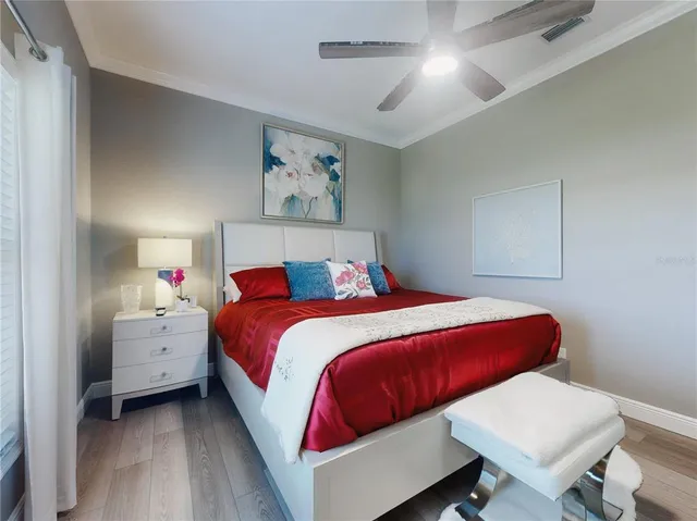 a bedroom with a large bed couch and a large window