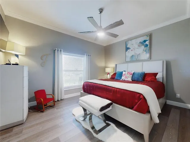 a bedroom with a bed and a chandelier