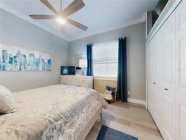 a bedroom with furniture and a wooden floor