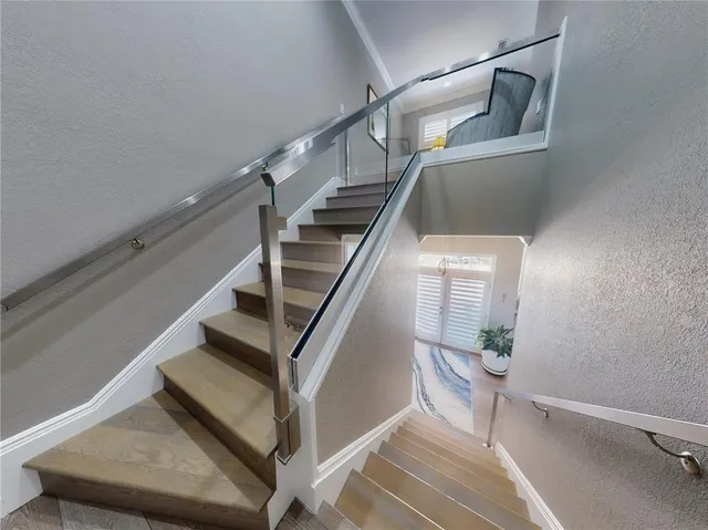 an aerial view of a house with a garden and lake view