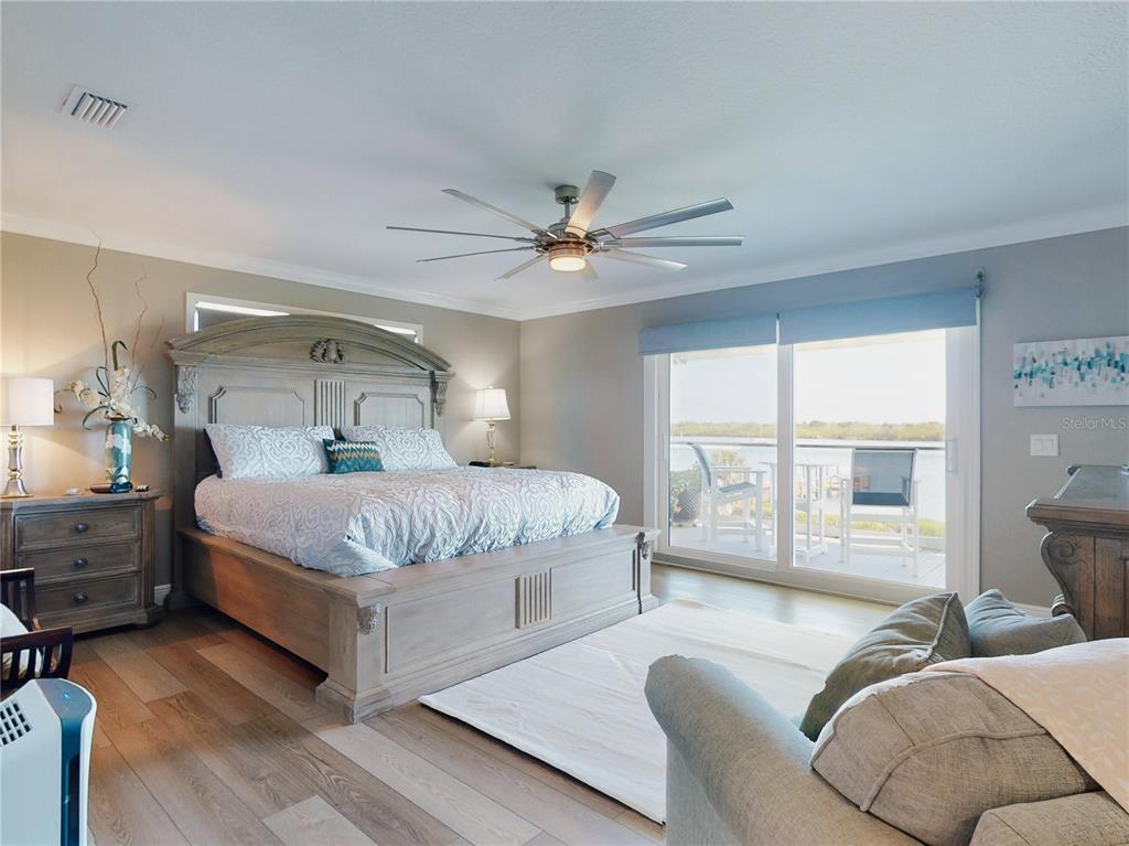 2019 South Riverside Drive Edgewater, FL 32141 - Photo 39 of 94 a bedroom with a large bed couch and a large window