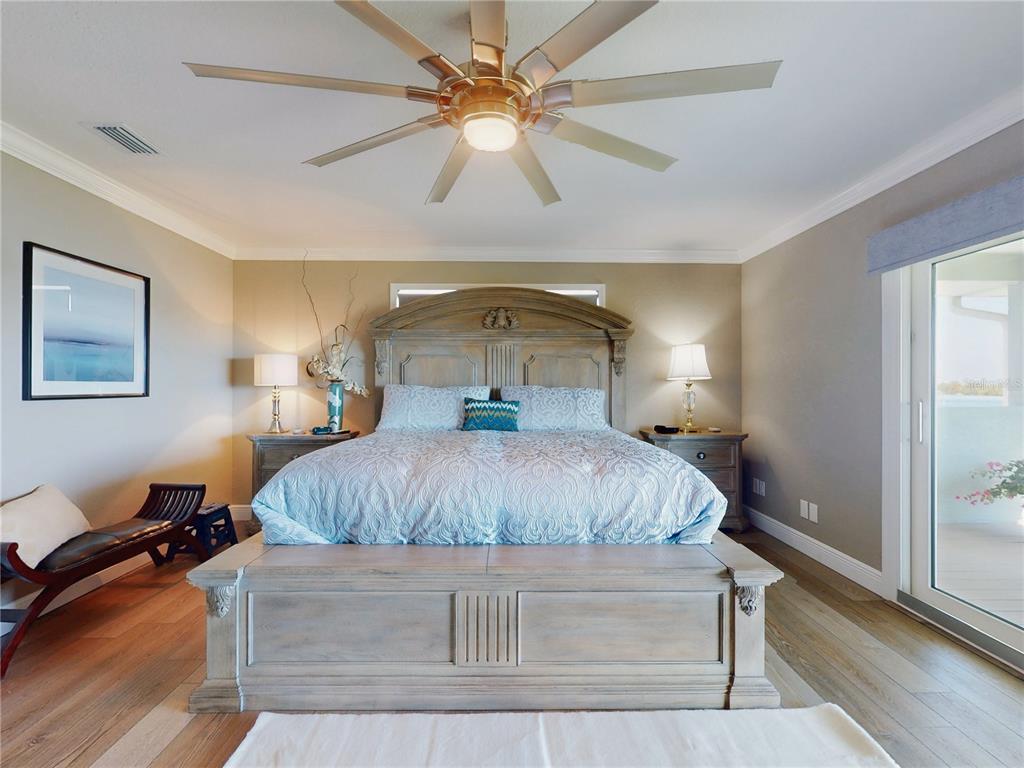 2019 South Riverside Drive Edgewater, FL 32141 - Photo 40 of 94 a bedroom with a bed and a chandelier