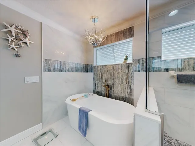 an aerial view of a house with outdoor seating lake view and boat