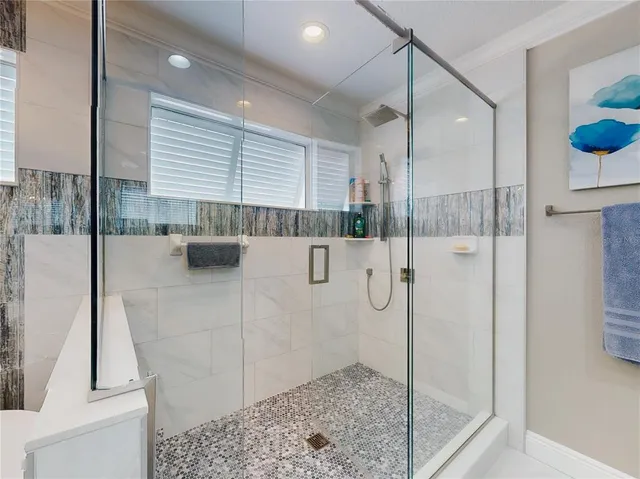 a view of a house with a yard and palm trees