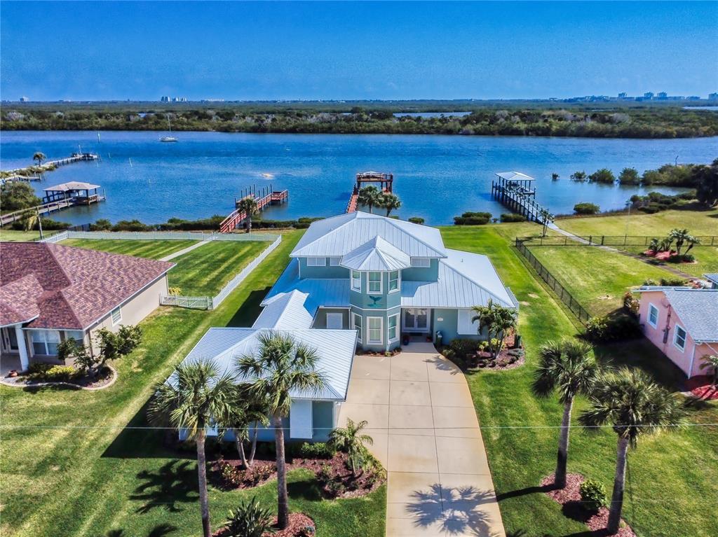 2019 South Riverside Drive Edgewater, FL 32141 - Photo 57 of 94 an aerial view of a house with a garden and lake view