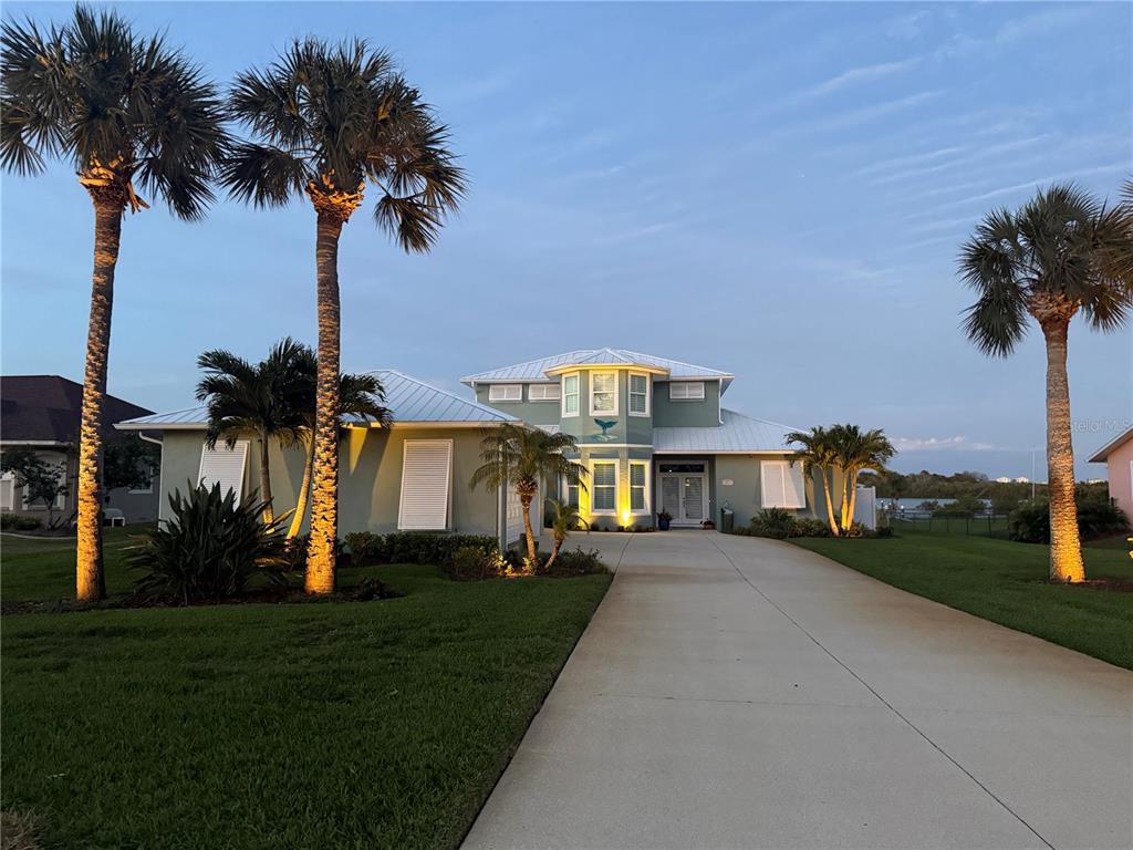 2019 South Riverside Drive Edgewater, FL 32141 - Photo 79 of 94 a view of a house with a yard and palm trees