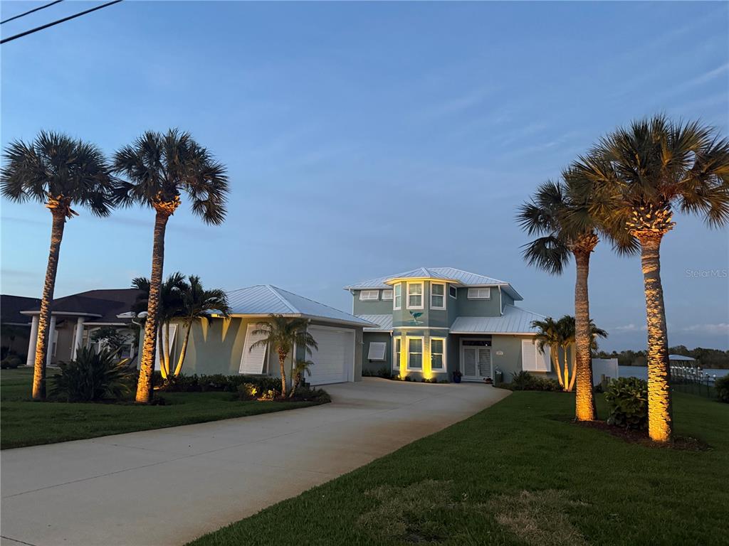 2019 South Riverside Drive Edgewater, FL 32141 - Photo 83 of 94 a front view of a house with a yard and garage