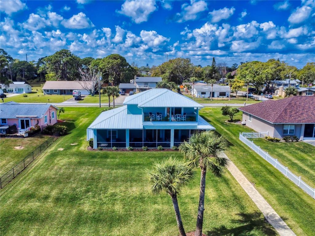 2019 South Riverside Drive Edgewater, FL 32141 - Photo 86 of 94 a view of a house with a yard table and chairs