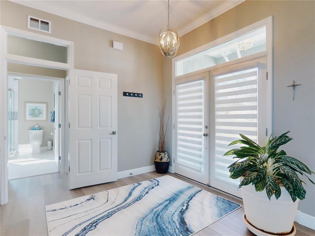 2019 South Riverside Drive Edgewater, FL 32141 - Photo 9 of 94 a bedroom with a bed and a potted plant