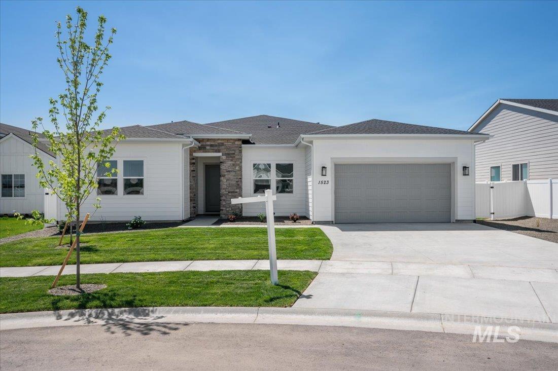 9131 West Moonglade Street Star, ID 83669 - Photo 1 of 22 View of front of property featuring driveway, a garage, stone siding, and roof with shingles