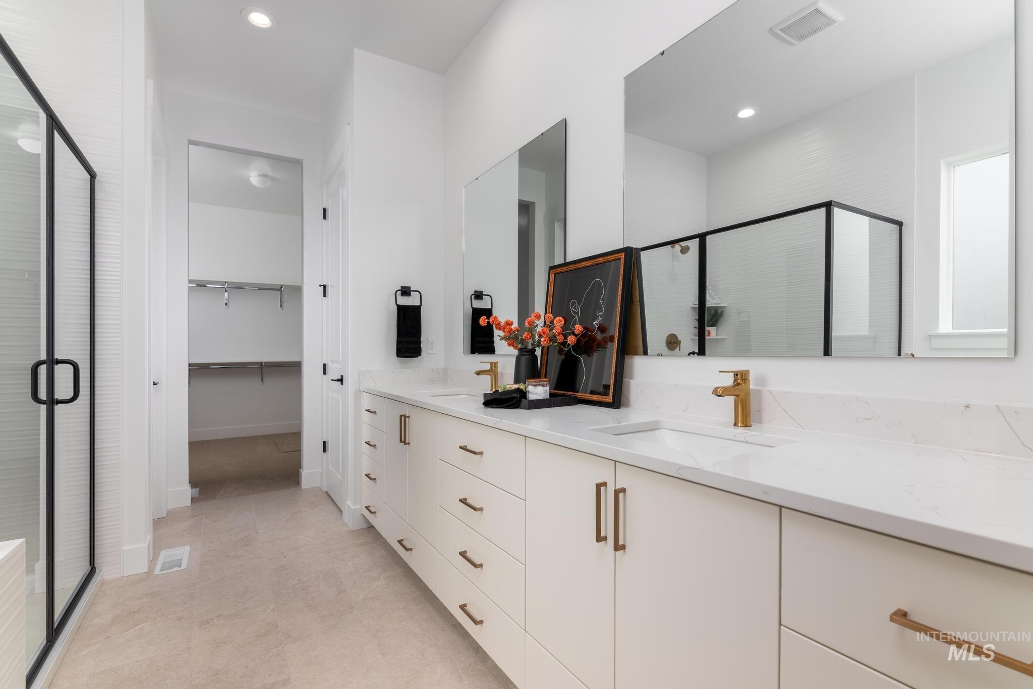 9131 West Moonglade Street Star, ID 83669 - Photo 8 of 22 Bathroom featuring double vanity, a stall shower, recessed lighting, and a spacious closet