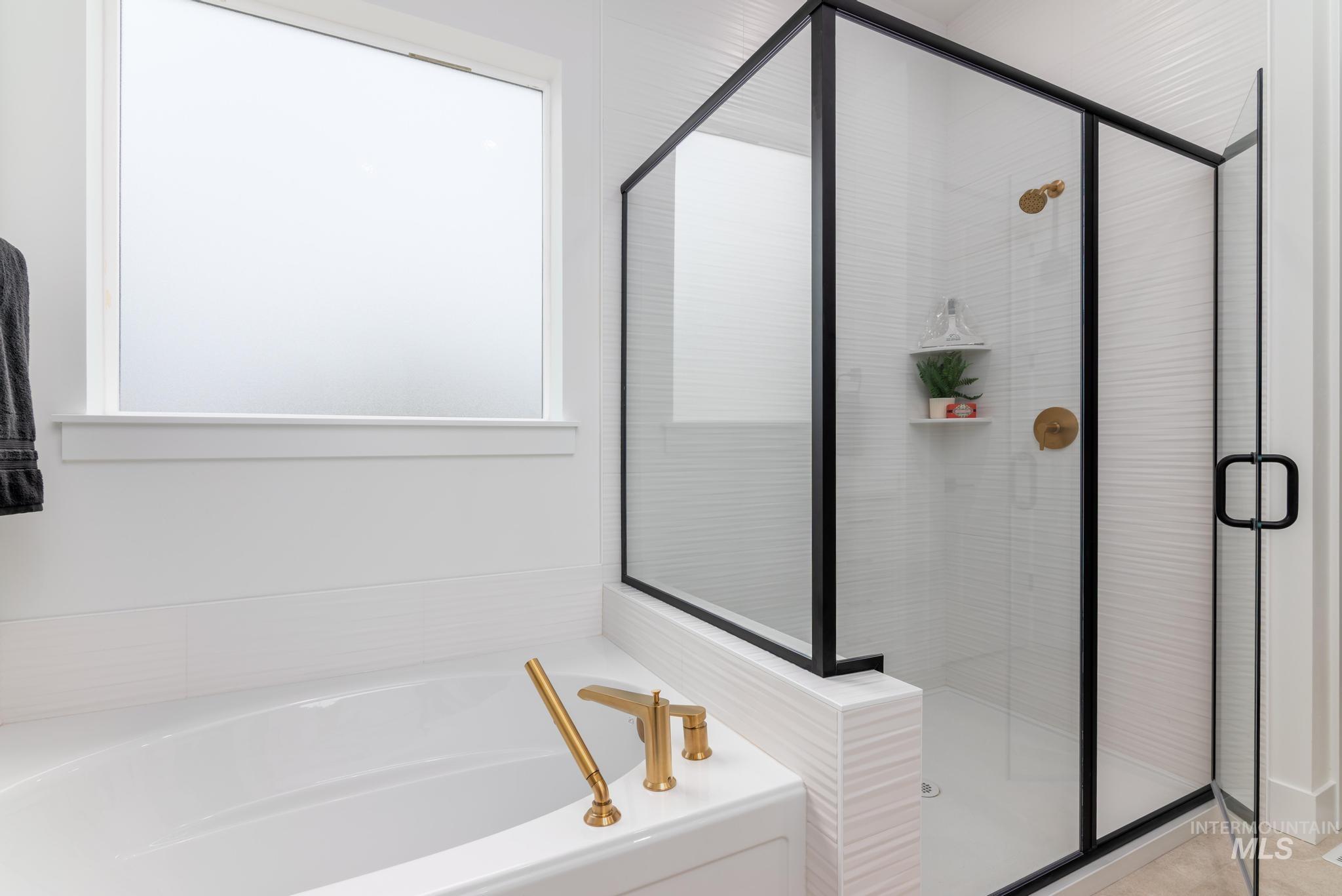 9131 West Moonglade Street Star, ID 83669 - Photo 9 of 22 Bathroom with a bath and a stall shower