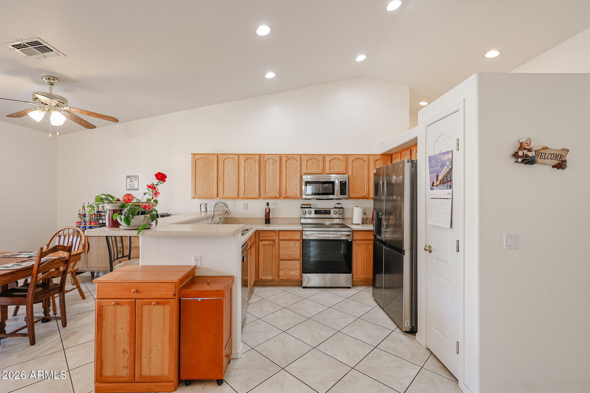 14980 South Capistrano Road Arizona City, AZ 85123 - Photo 9 of 39 a kitchen with stainless steel appliances kitchen island granite countertop a refrigerator and a stove top oven