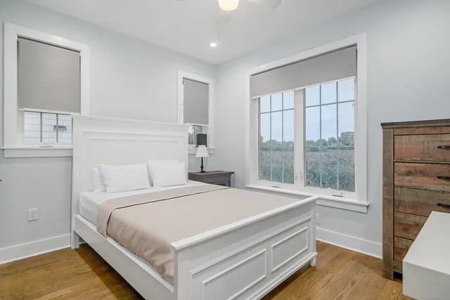 a bedroom with a bed and a large window