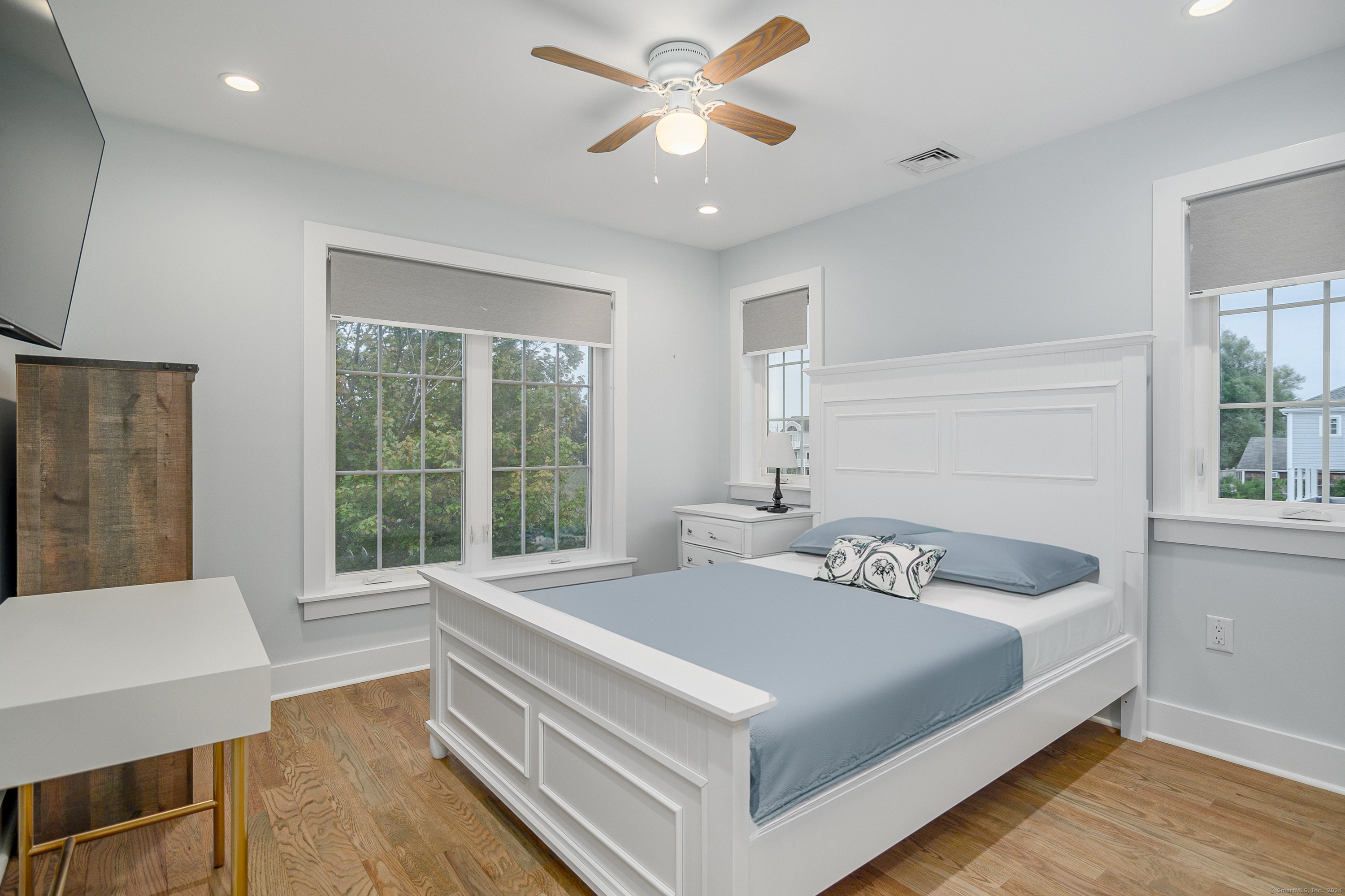 1039 Reef Road Fairfield, CT 06824 - Photo 14 of 26 a bedroom with a bed and a large window