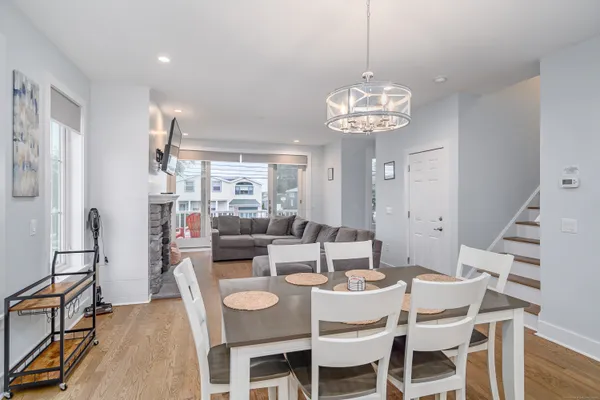 a view of a dining room with furniture wooden floor and chandelier
