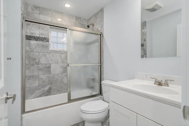 a bathroom with a sink toilet and shower