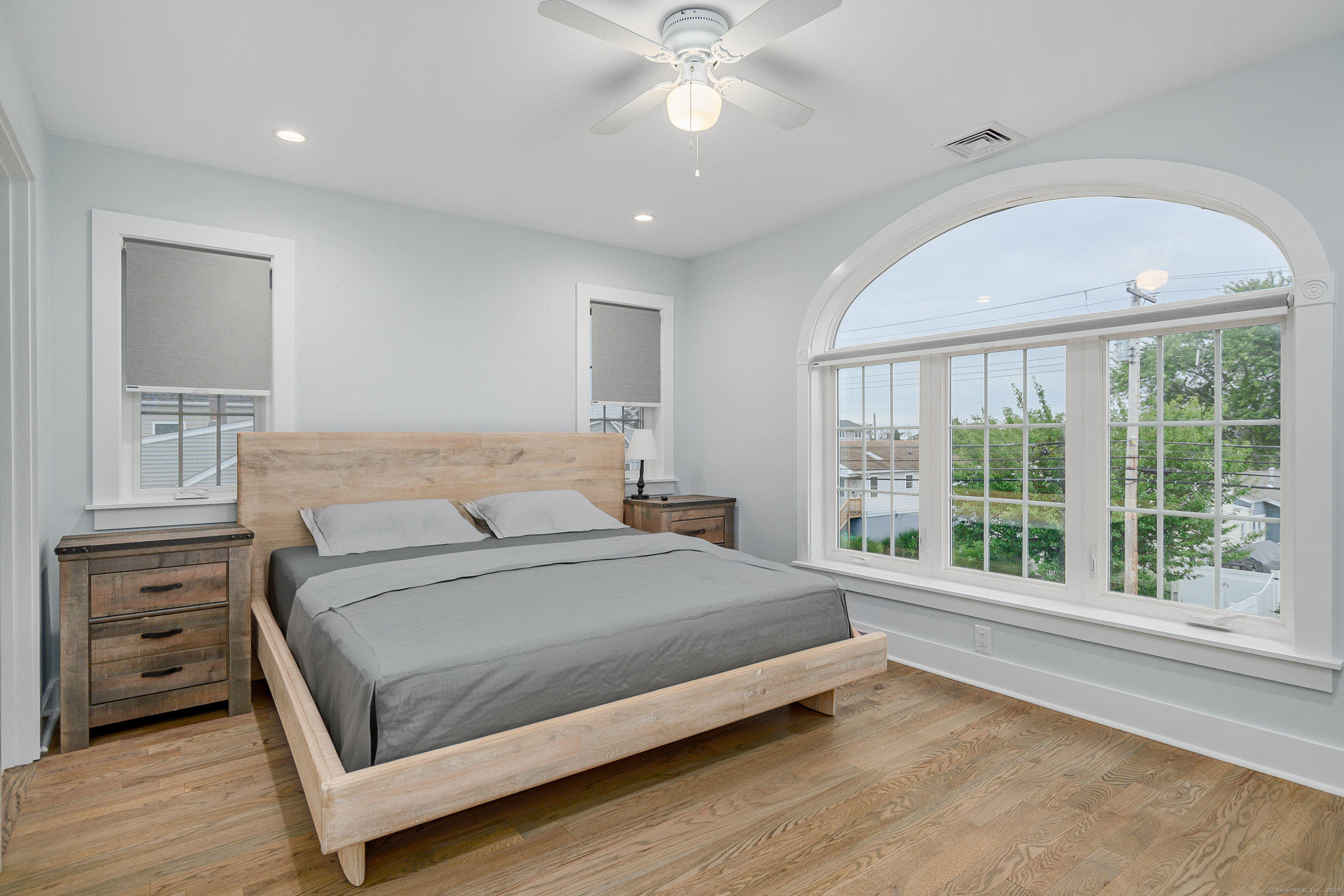 1039 Reef Road Fairfield, CT 06824 - Photo 17 of 26 a bedroom with a large bed and a large window